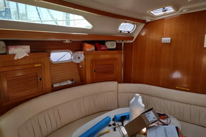 Spotted Drum II Yacht Photos Pics Interior of a 2004 Catalina 42 Mk II sailboat with wooden paneling and seating area.