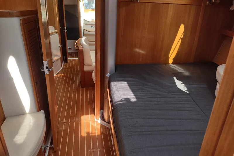 Spotted Drum II Yacht Photos Pics Interior of 2004 Catalina 42 Mk II sailboat with wooden finish and cozy sleeping area.