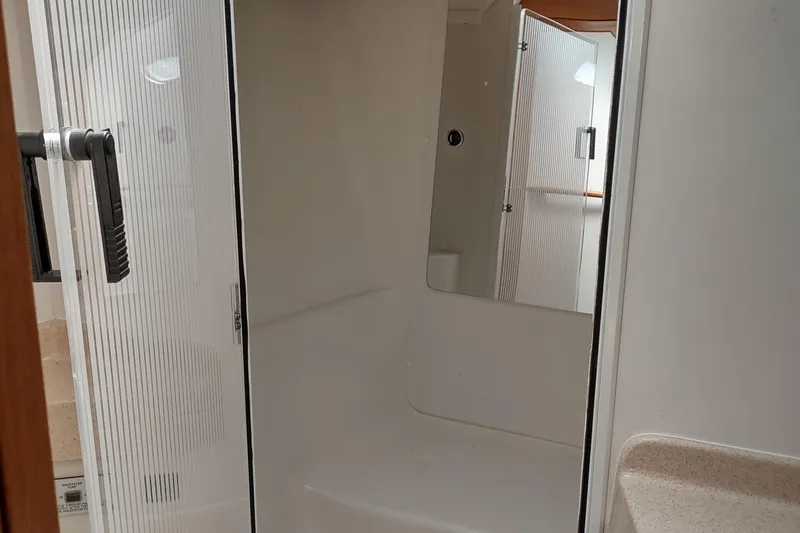 Spotted Drum II Yacht Photos Pics Bathroom interior of a 2004 Catalina 42 Mk II yacht, featuring a shower and sink.