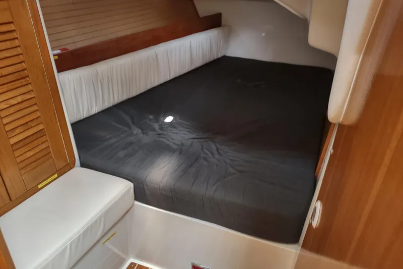 Spotted Drum II Yacht Photos Pics 2004 Catalina 42 Mk II yacht cabin with a spacious bed and wooden interior.