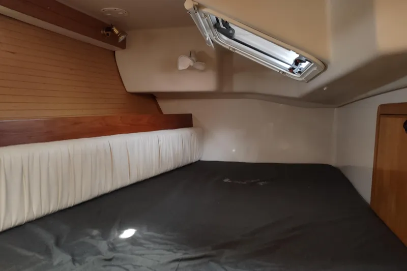 Spotted Drum II Yacht Photos Pics Cozy cabin interior of 2004 Catalina 42 Mk II sailboat with bed and porthole.