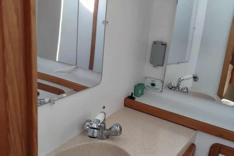 Spotted Drum II Yacht Photos Pics Bathroom interior of 2004 Catalina 42 Mk II yacht with sink and mirror.
