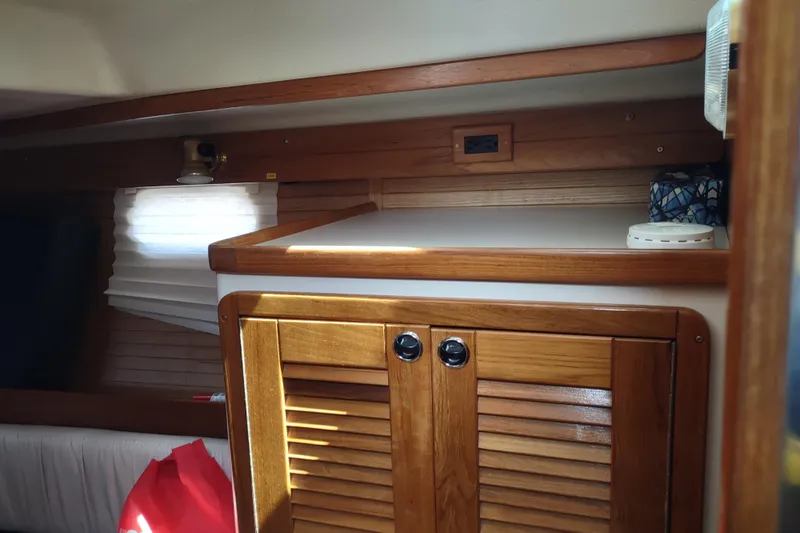 Spotted Drum II Yacht Photos Pics Interior of 2004 Catalina 42 Mk II sailboat with wooden cabinetry and soft lighting.
