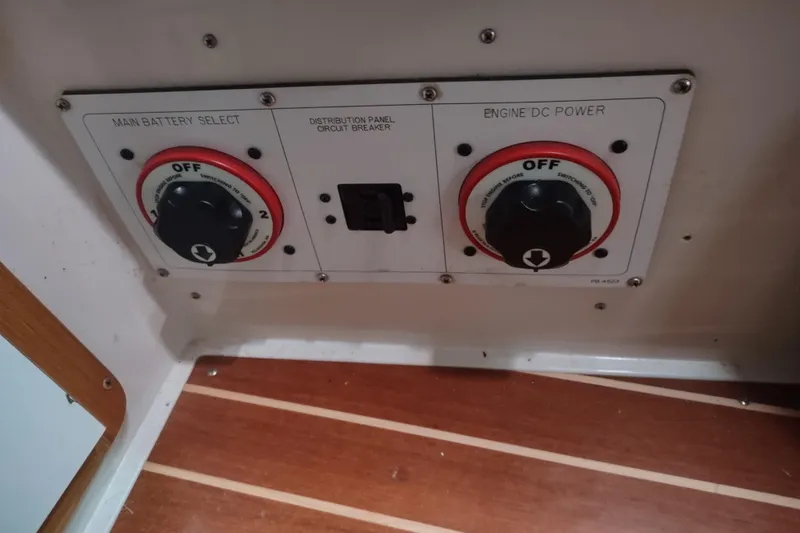 Spotted Drum II Yacht Photos Pics Battery control panel on a 2004 Catalina 42 Mk II sailboat, featuring main battery and engine power switches.