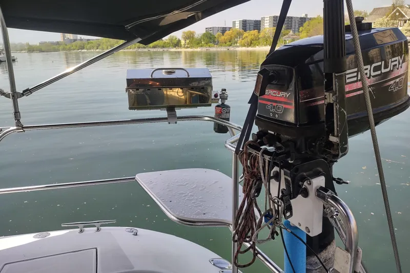 Spotted Drum II Yacht Photos Pics Catalina 42 Mk II sailboat with Mercury outboard motor on calm water, 2004 model.