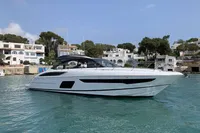 2016 Princess V58 Open yacht on calm water near coastal buildings.