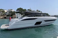 2016 Princess V58 Open yacht on calm water near coastal buildings.