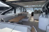 Luxurious 2016 Princess V58 Open yacht interior with elegant seating and wooden table.