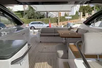 Luxurious 2016 Princess V58 Open yacht interior with elegant seating and wooden table.