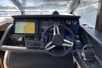 Helm of 2016 Princess V58 Open yacht with navigation screens and controls.