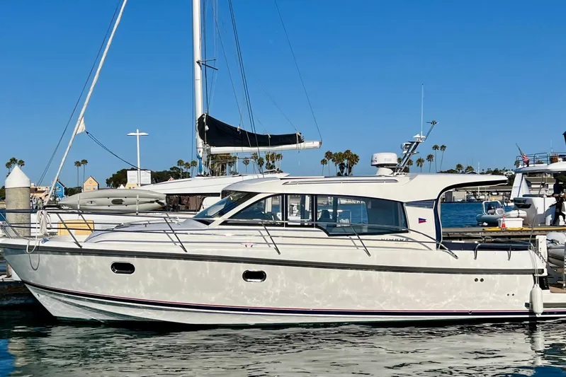 Kala Yacht Photos Pics 2018 Nimbus 365 Coupe yacht docked in sunny marina with clear blue sky.