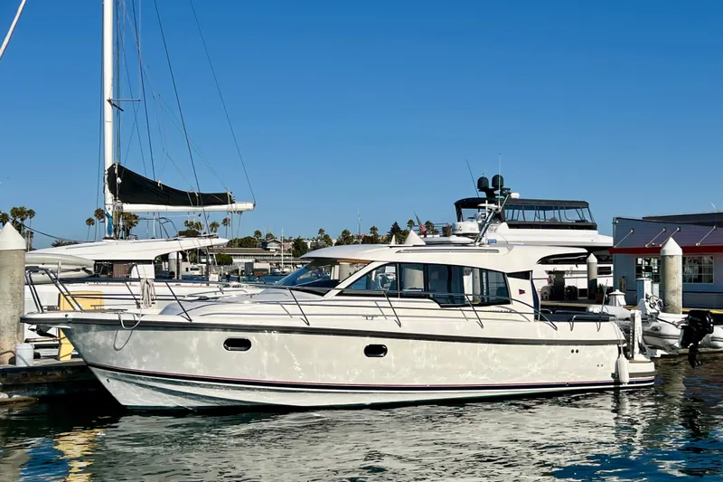 Kala Yacht Photos Pics 2018 Nimbus 365 Coupe yacht docked at a marina under clear blue skies.