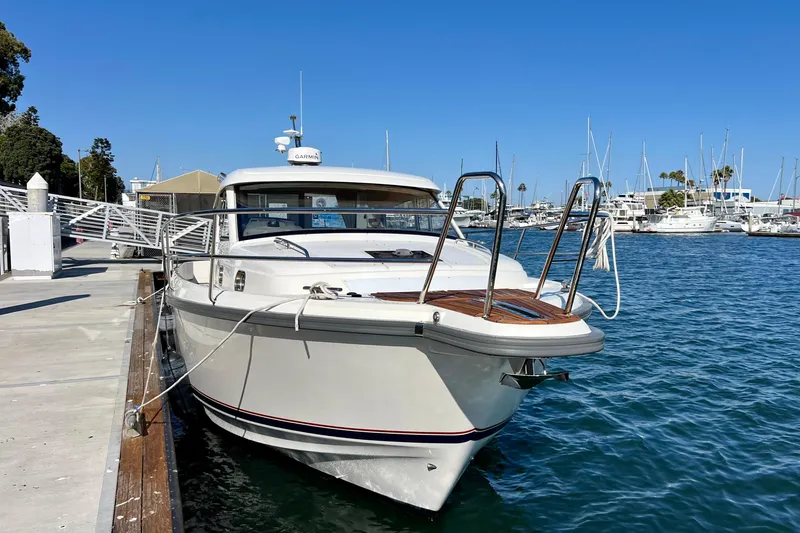 Kala Yacht Photos Pics 2018 Nimbus 365 Coupe docked at marina, clear blue sky, calm water.