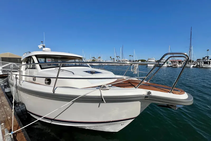 Kala Yacht Photos Pics 2018 Nimbus 365 Coupe docked at marina under clear blue sky.