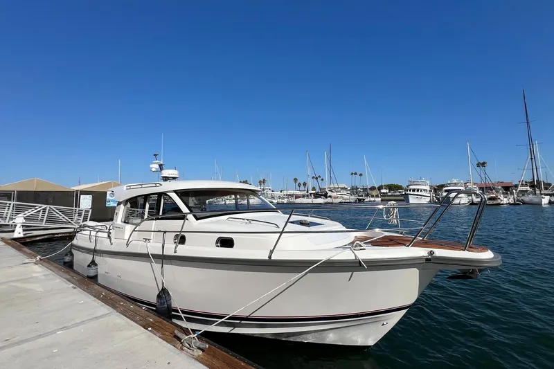 Kala Yacht Photos Pics 2018 Nimbus 365 Coupe docked at a marina under clear blue skies.
