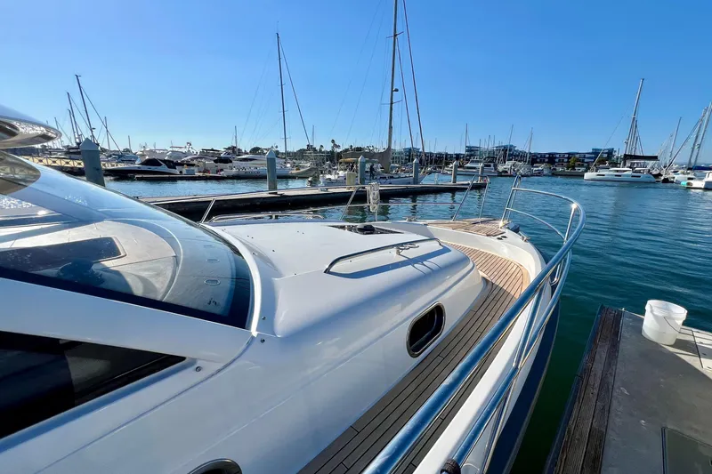 Kala Yacht Photos Pics 2018 Nimbus 365 Coupe yacht docked at a marina with clear blue skies.