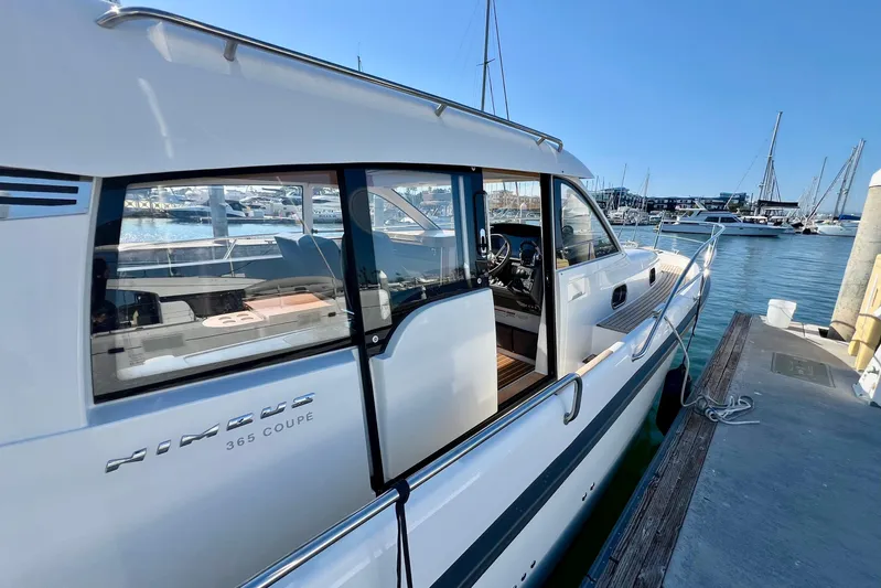Kala Yacht Photos Pics 2018 Nimbus 365 Coupe docked at marina, showcasing sleek design and open cabin.