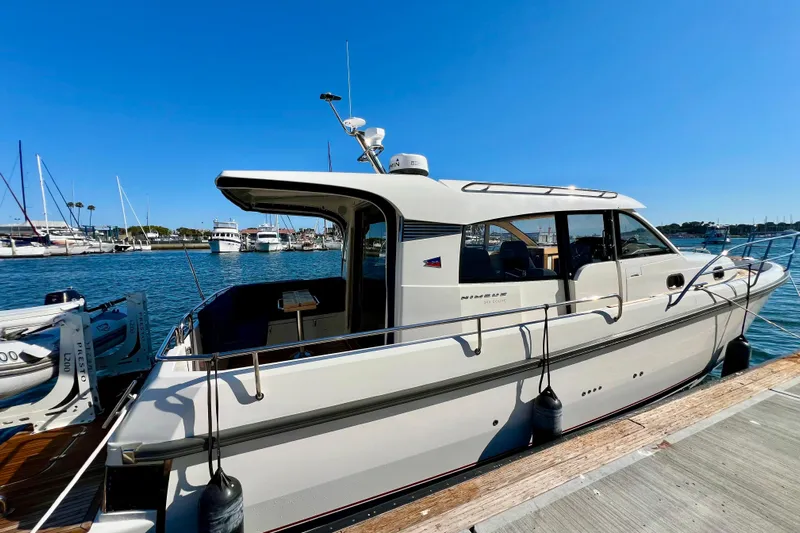 Kala Yacht Photos Pics 2018 Nimbus 365 Coupe docked at marina under clear blue sky.