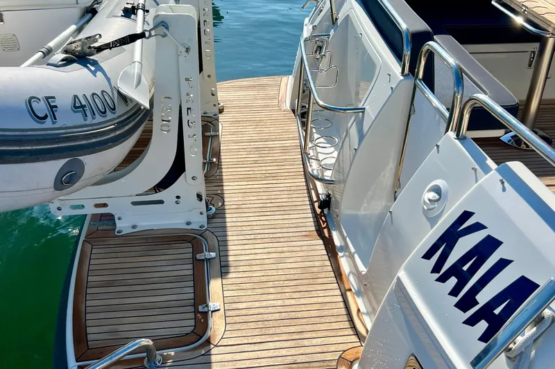 Kala Yacht Photos Pics 2018 Nimbus 365 Coupe yacht with wooden deck and attached inflatable boat.