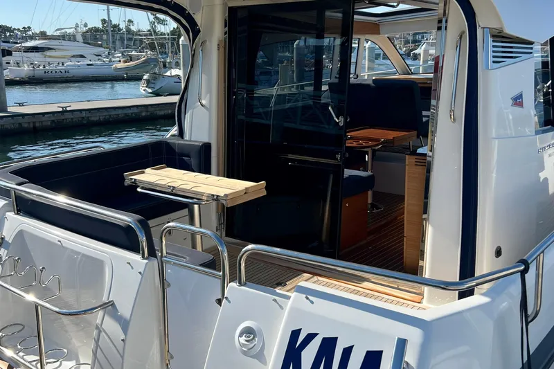 Kala Yacht Photos Pics 2018 Nimbus 365 Coupe yacht docked, showcasing open deck and interior seating area.