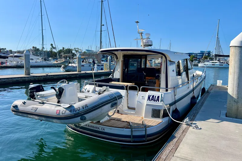 Kala Yacht Photos Pics 2018 Nimbus 365 Coupe docked with inflatable boat, marina background.