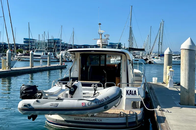 Kala Yacht Photos Pics 2018 Nimbus 365 Coupe docked at marina, Santa Barbara, with inflatable boat attached.