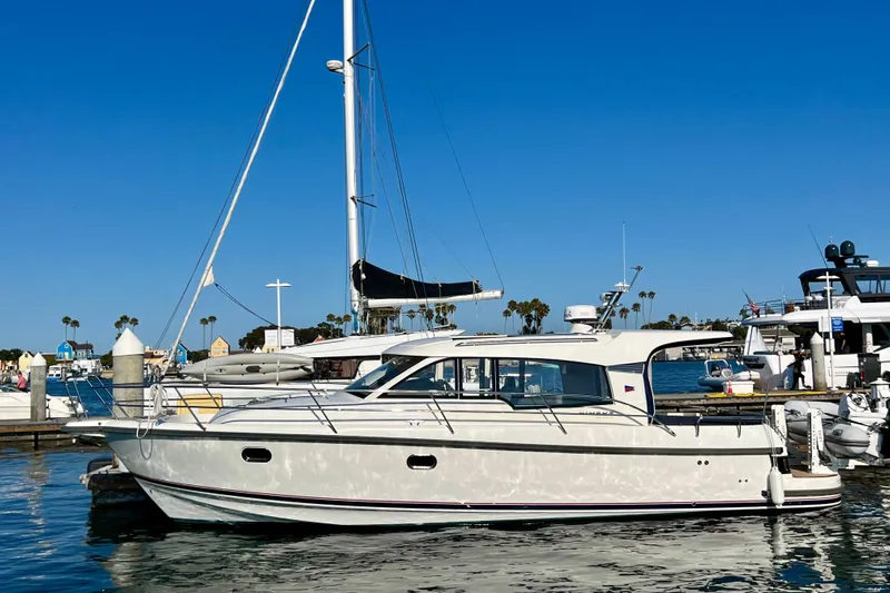 Kala Yacht Photos Pics 2018 Nimbus 365 Coupe yacht docked in a sunny marina, clear blue sky.
