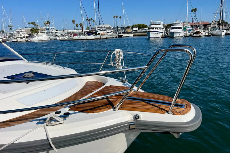Kala Yacht Photos Pics 2018 Nimbus 365 Coupe yacht docked in a marina with clear blue water.