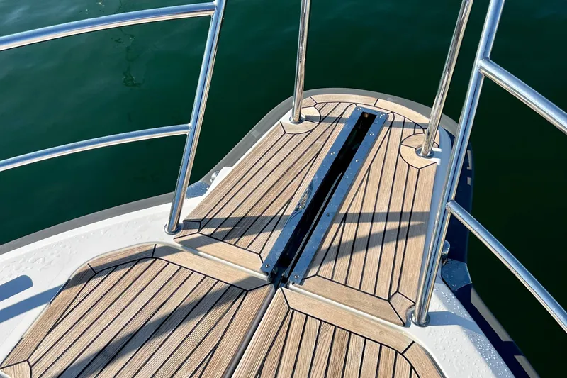 Kala Yacht Photos Pics Bow deck of 2018 Nimbus 365 Coupe with teak flooring and stainless steel railings.