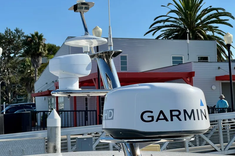 Kala Yacht Photos Pics Garmin radar on 2018 Nimbus 365 Coupe boat, docked near palm trees and buildings.
