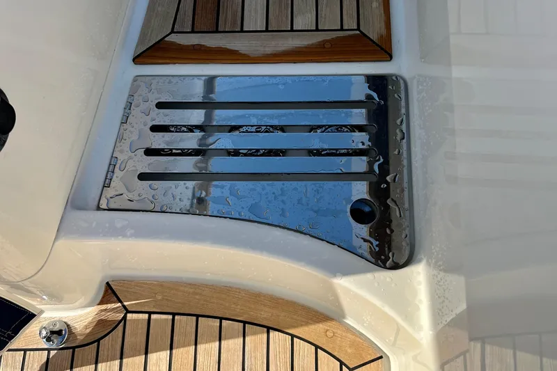 Kala Yacht Photos Pics Stainless steel deck detail on 2018 Nimbus 365 Coupe, featuring wood accents and water droplets.