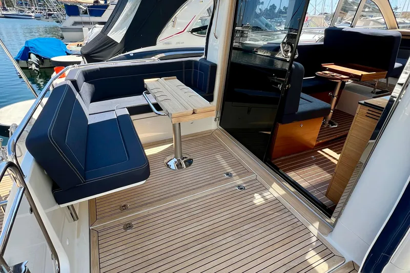 Kala Yacht Photos Pics 2018 Nimbus 365 Coupe yacht interior with sleek seating and wooden flooring.