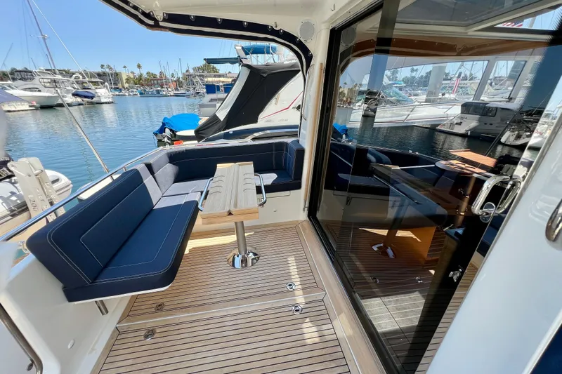 Kala Yacht Photos Pics 2018 Nimbus 365 Coupe yacht interior with seating and table, docked at marina.