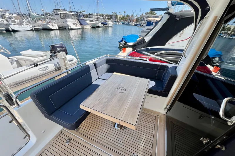Kala Yacht Photos Pics Luxurious 2018 Nimbus 365 Coupe yacht interior with elegant seating and table in marina.