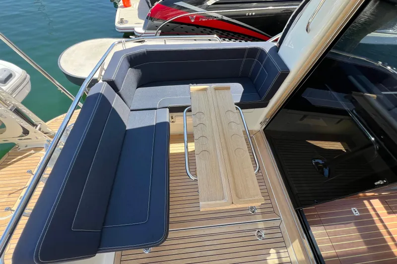 Kala Yacht Photos Pics Luxurious seating area on 2018 Nimbus 365 Coupe yacht with wooden table.