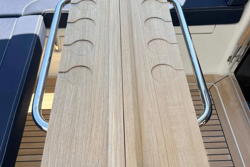 Kala Yacht Photos Pics Wooden table with cup holders on a 2018 Nimbus 365 Coupe boat deck.