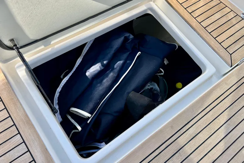 Kala Yacht Photos Pics Storage compartment on 2018 Nimbus 365 Coupe boat with blue bag inside.