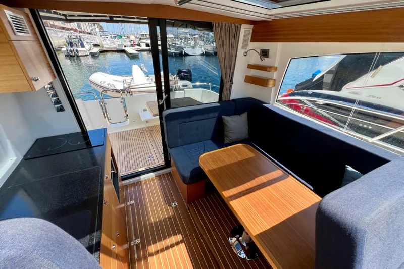 Kala Yacht Photos Pics Interior of 2018 Nimbus 365 Coupe yacht with wooden flooring and marina view.