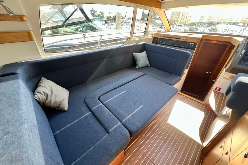 Kala Yacht Photos Pics Interior of 2018 Nimbus 365 Coupe with blue seating and wooden accents.