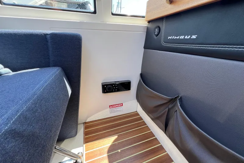 Kala Yacht Photos Pics Interior of 2018 Nimbus 365 Coupe with blue seating and wood flooring.