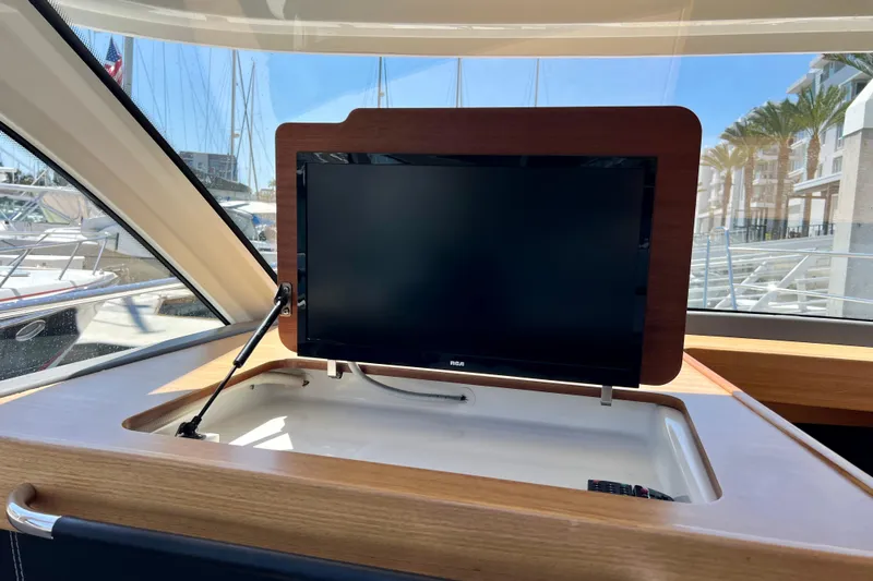 Kala Yacht Photos Pics Flat-screen TV on 2018 Nimbus 365 Coupe yacht, docked with marina view.