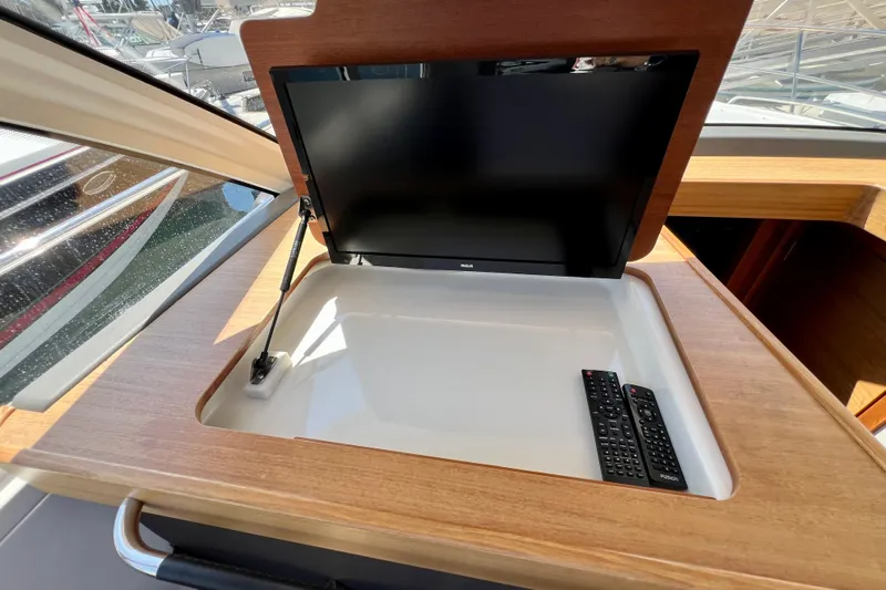 Kala Yacht Photos Pics Built-in TV and remote controls on 2018 Nimbus 365 Coupe yacht interior.