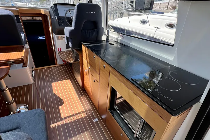 Kala Yacht Photos Pics Interior of 2018 Nimbus 365 Coupe with modern kitchen and steering area.