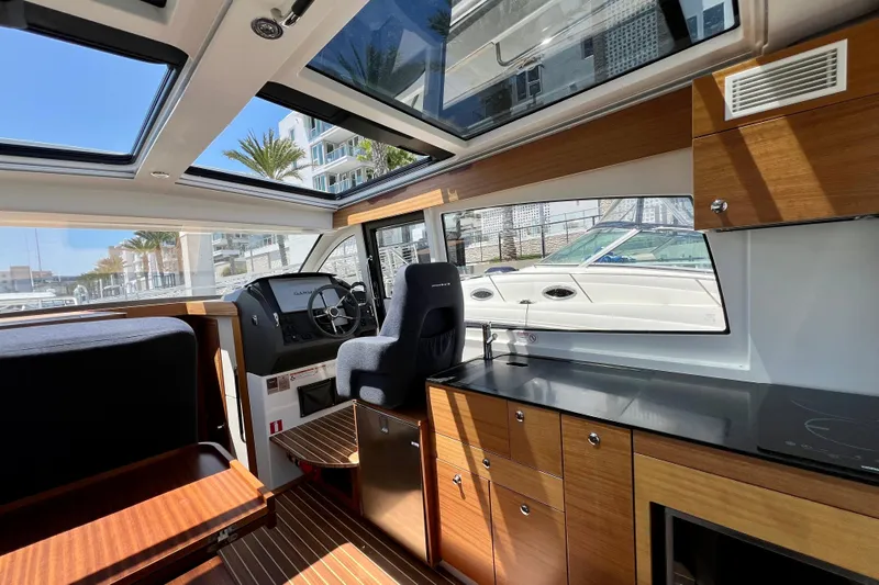 Kala Yacht Photos Pics Interior of 2018 Nimbus 365 Coupe boat with modern helm and kitchen area.