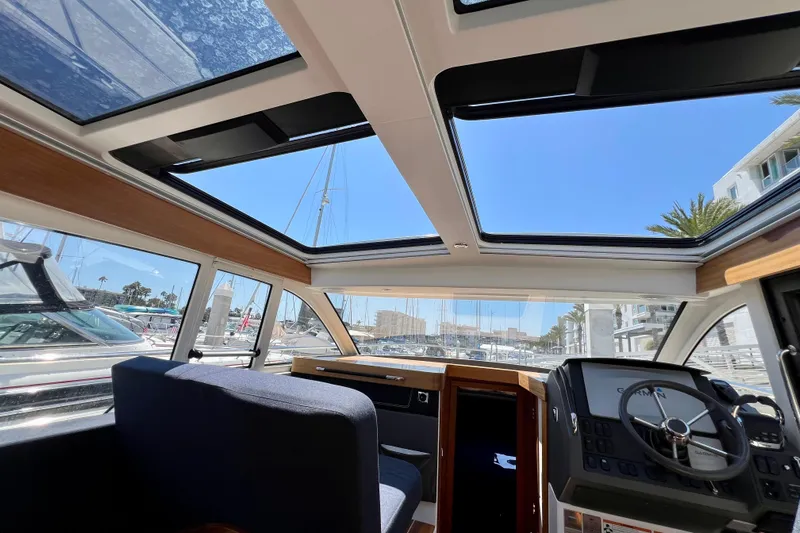 Kala Yacht Photos Pics Interior view of 2018 Nimbus 365 Coupe boat with sunroof and modern dashboard.