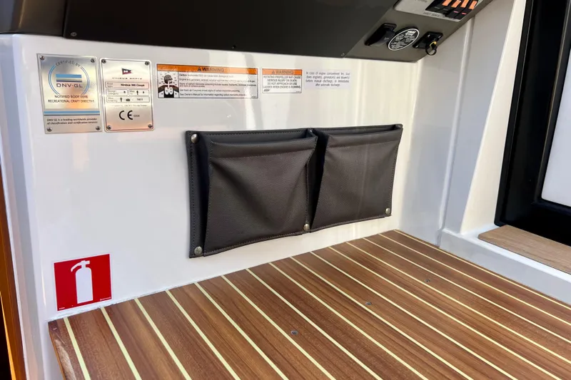 Kala Yacht Photos Pics Interior of 2018 Nimbus 365 Coupe with safety labels and storage pouches.