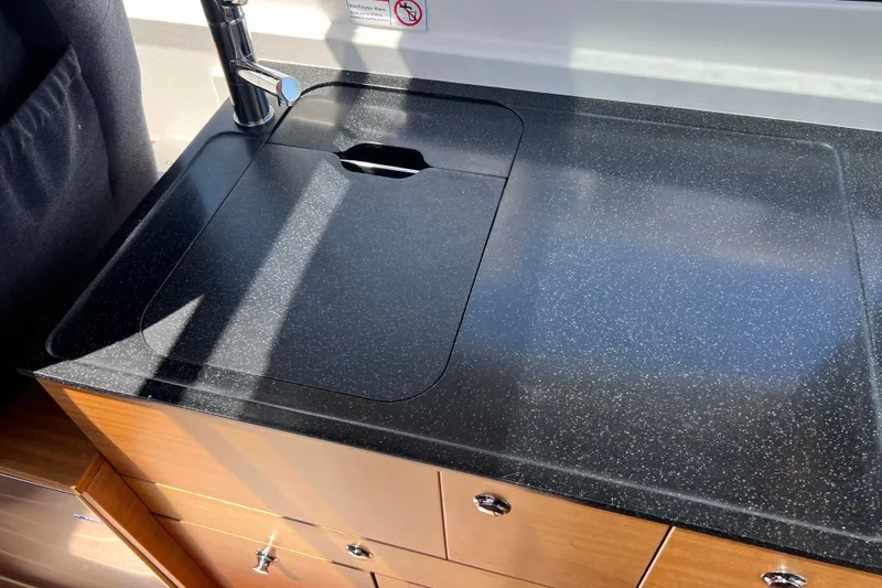 Kala Yacht Photos Pics Modern kitchen sink in 2018 Nimbus 365 Coupe boat, featuring sleek black countertop.
