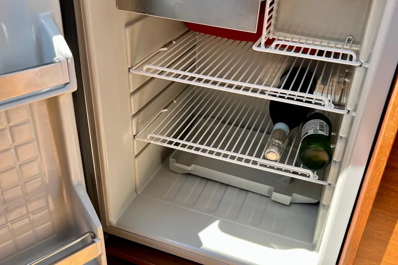 Kala Yacht Photos Pics Open fridge in 2018 Nimbus 365 Coupe with bottles on shelves.