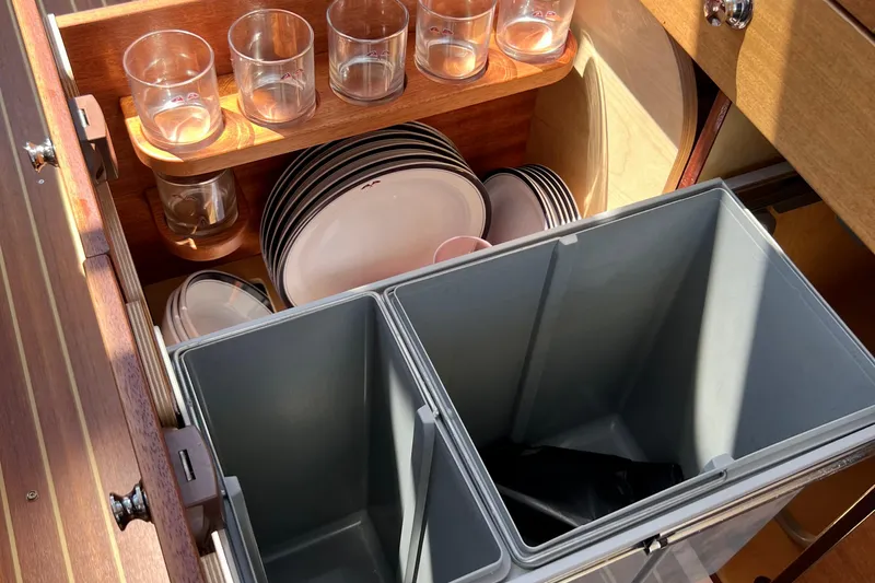 Kala Yacht Photos Pics Kitchen storage in 2018 Nimbus 365 Coupe with glasses, plates, and bins.