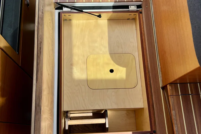 Kala Yacht Photos Pics Wooden storage compartment in 2018 Nimbus 365 Coupe boat interior.